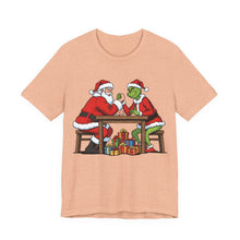 Load image into Gallery viewer, Santa vs The Grinch – Funny Christmas Graphic Tee (Unisex) Heather Peach