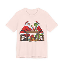 Load image into Gallery viewer, Santa vs The Grinch – Funny Christmas Graphic Tee (Unisex) Soft Pink